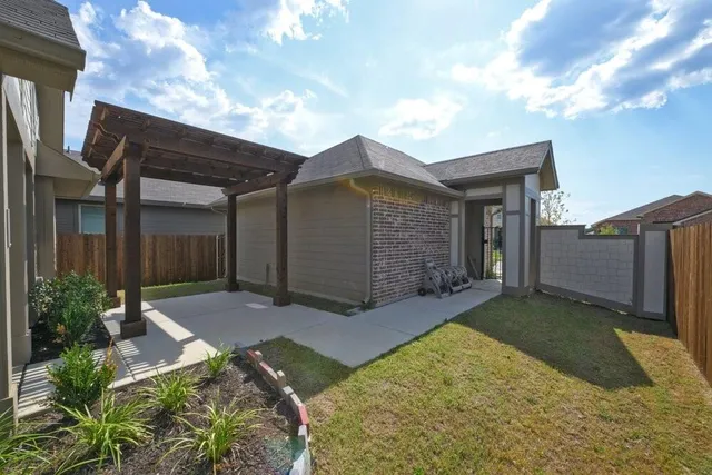 a view of a house with a small yard and potted plants
