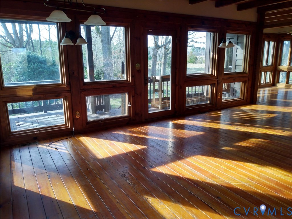 2174 Grubby Road Halifax, VA 24558 - Photo 11 of 25 a view of empty room with floor to ceiling window and wooden floor