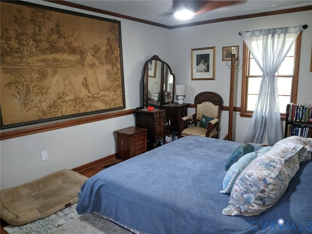 2174 Grubby Road Halifax, VA 24558 - Photo 19 of 25 a bed sitting in a bedroom next to a window with computer on desk and chair