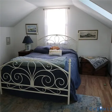 a bedroom with a bed and a stove