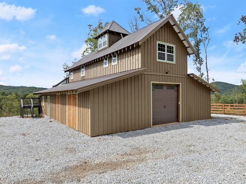 144 David Drive Tiger, GA 30576 - Photo 11 of 71 a front view of a house with a yard and garage