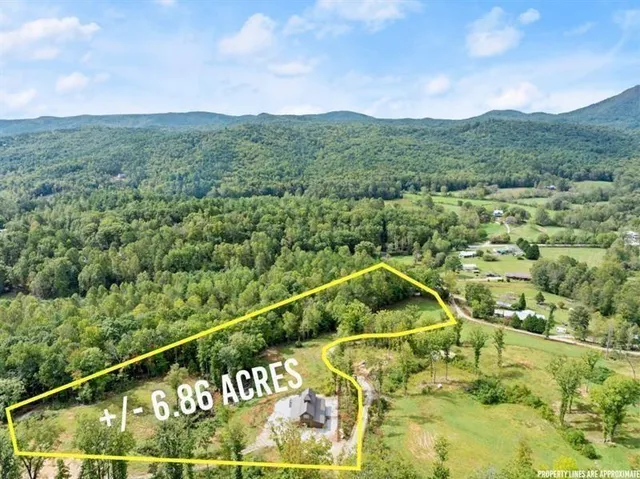 a bathroom with a granite countertop toilet a sink a mirror and a shower