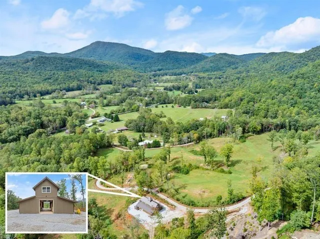 a view of a house with a backyard and tree