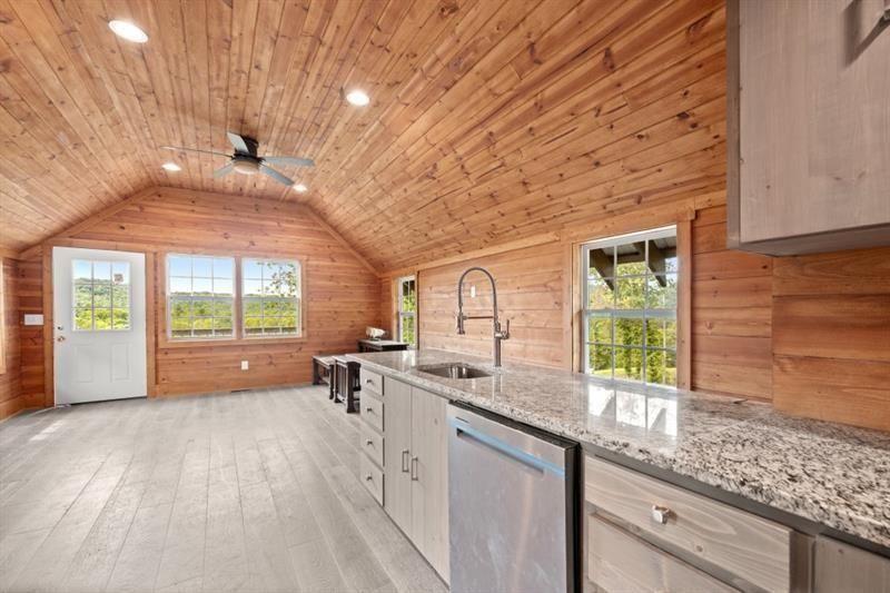 144 David Drive Tiger, GA 30576 - Photo 67 of 71 a open kitchen with granite countertop a sink dishwasher a stove and white cabinets with wooden floor