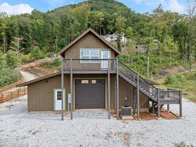 a view of a green yard with mountains in the background