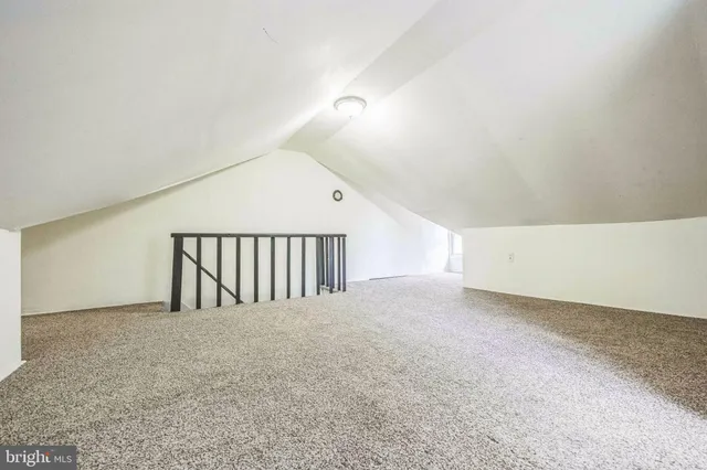 a view of an empty room and stairs