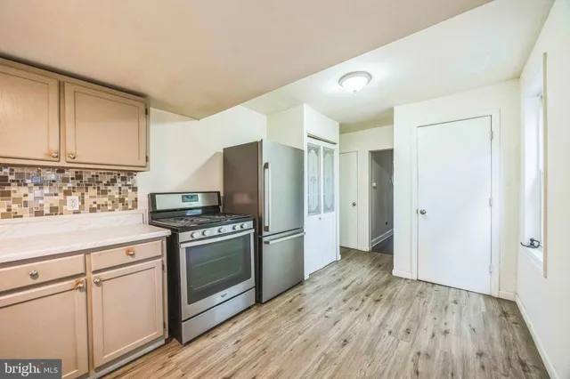a kitchen with a stove a refrigerator and a sink