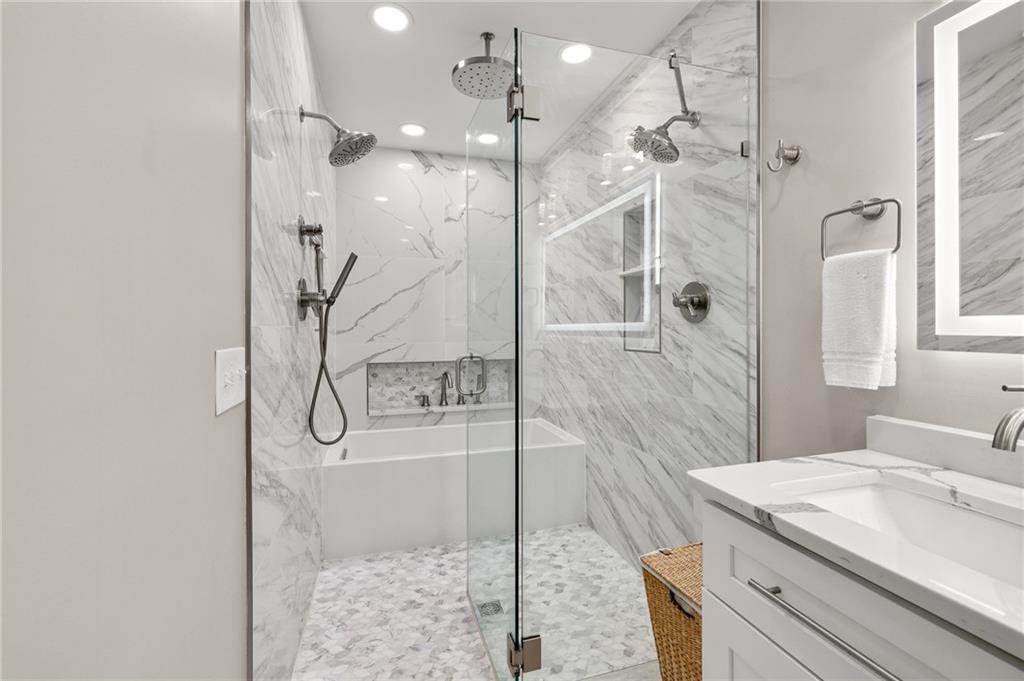 6470 Samoa Way Flowery Branch, GA 30542 - Photo 38 of 61 a bathroom with a granite countertop sink a toilet and shower
