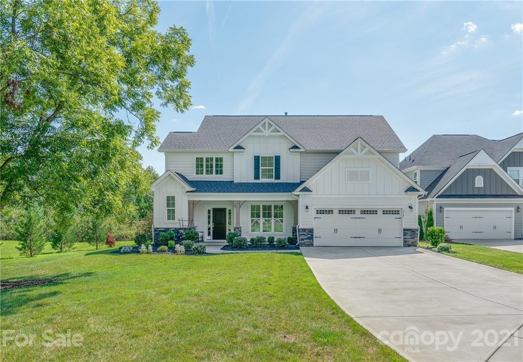 2701 Walker Road Matthews, NC 28105 - Photo 1 of 32 a front view of a house with a garden and yard