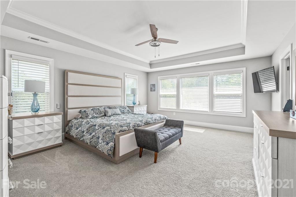 2701 Walker Road Matthews, NC 28105 - Photo 13 of 32 a spacious bedroom with a bed a dresser and a window