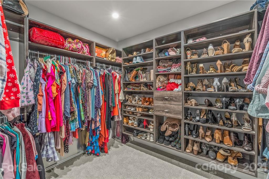 2701 Walker Road Matthews, NC 28105 - Photo 16 of 32 a view of walk in closet with clothes and shoes