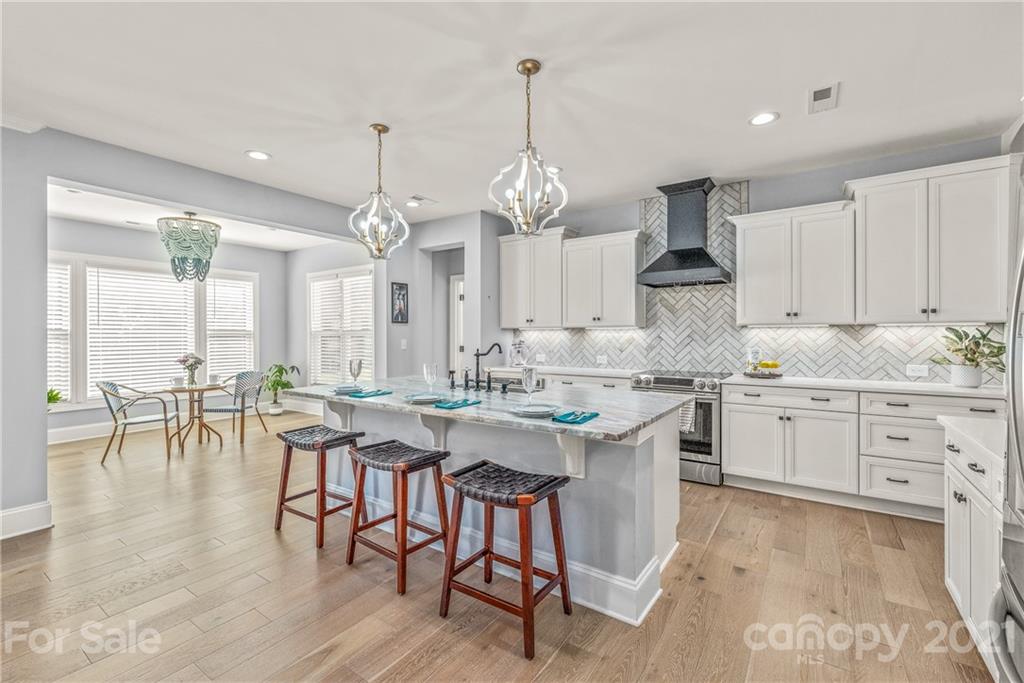 2701 Walker Road Matthews, NC 28105 - Photo 6 of 32 a kitchen with center island table and chairs in it
