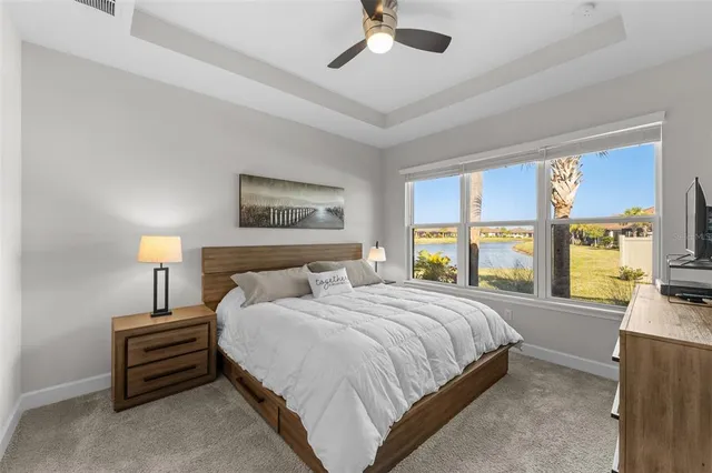 a bedroom with a bed and a large window