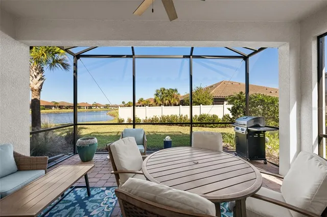 a dining room with furniture and a floor to ceiling window