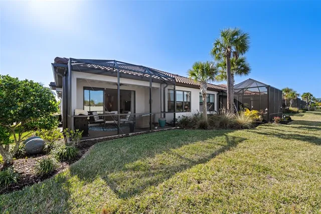 a view of a house with backyard porch and sitting area