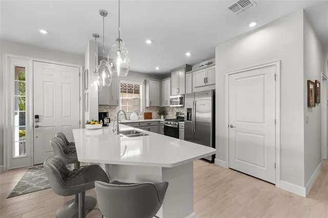 a large kitchen with dining table and chairs