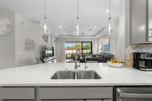 a kitchen with a sink and chandelier
