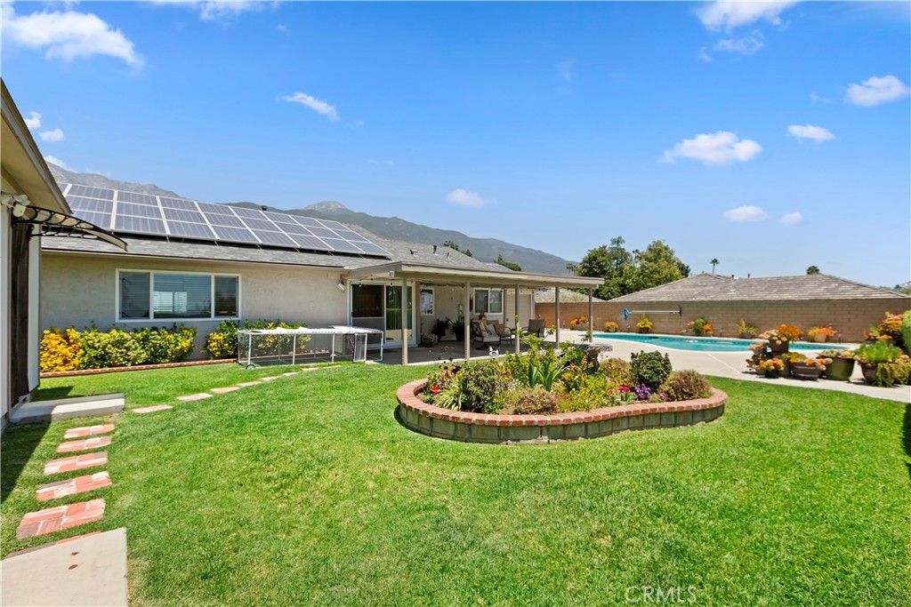 8527 Hillside Road Rancho Cucamonga, CA 91701 - Photo 33 of 50 a front view of a house with a garden and patio