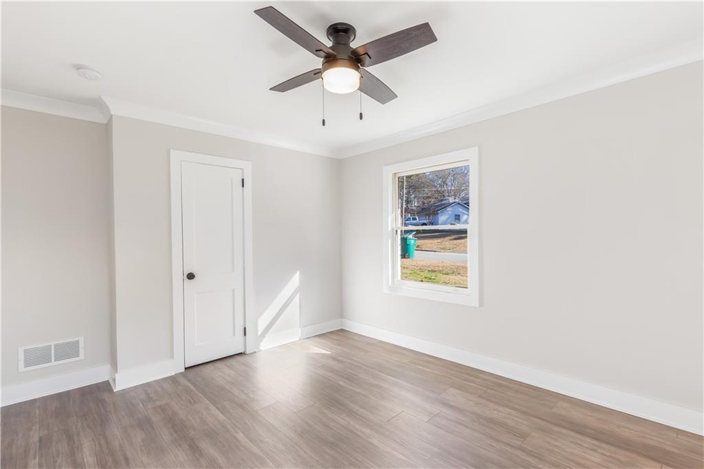 2260 Old Spring Road Smyrna, GA 30080 - Photo 22 of 29 a view of an empty room with window and wooden floor