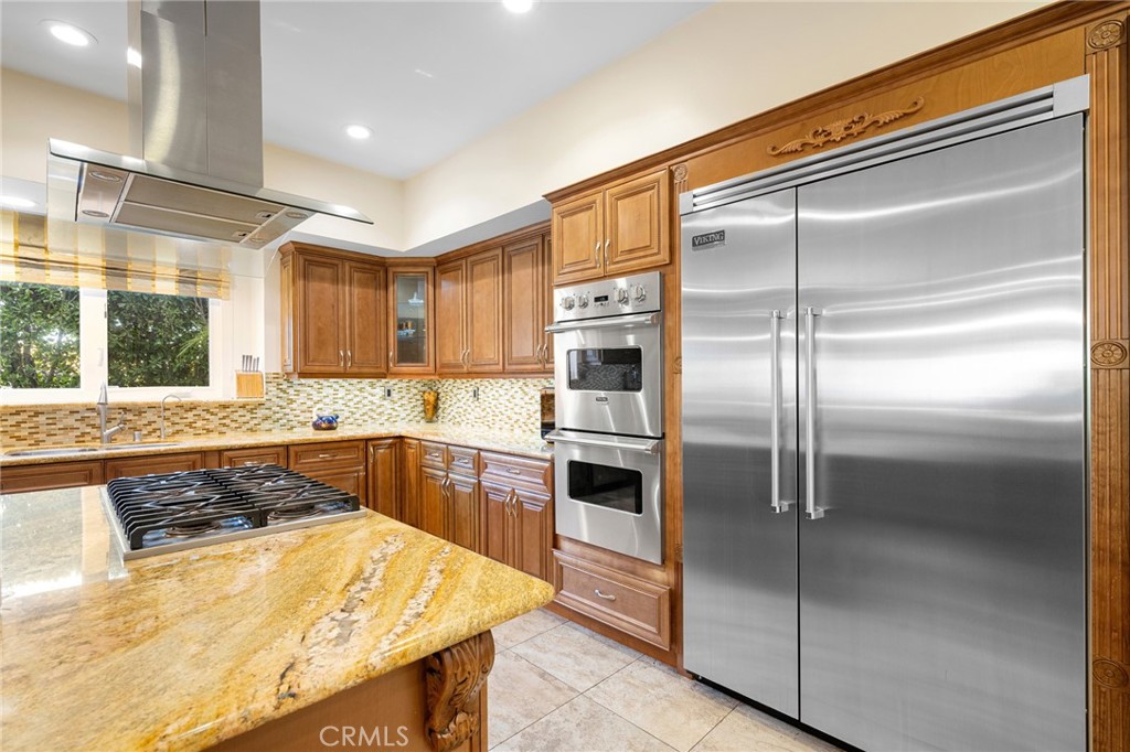 3331 Oakmont View Drive Glendale, CA 91208 - Photo 18 of 50 a large kitchen with a refrigerator a sink dishwasher a stove and a refrigerator with wooden floor