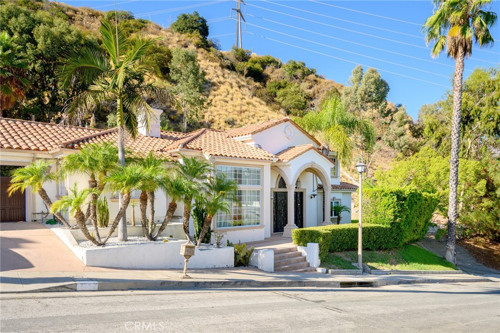 3331 Oakmont View Drive Glendale, CA 91208 - Photo 2 of 50 a view of a white house with a palm tree