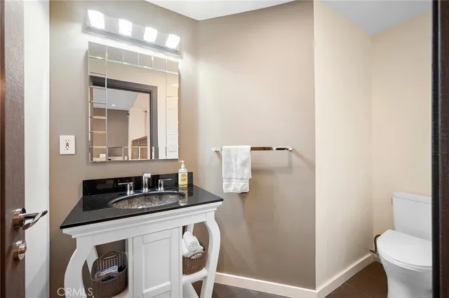 a bathroom with a sink toilet and mirror