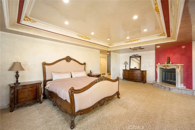 a spacious bedroom with a bed and a fireplace