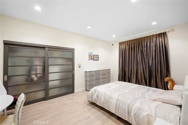 a bedroom with a bed and a closet