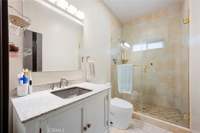 a bathroom with a sink toilet and shower