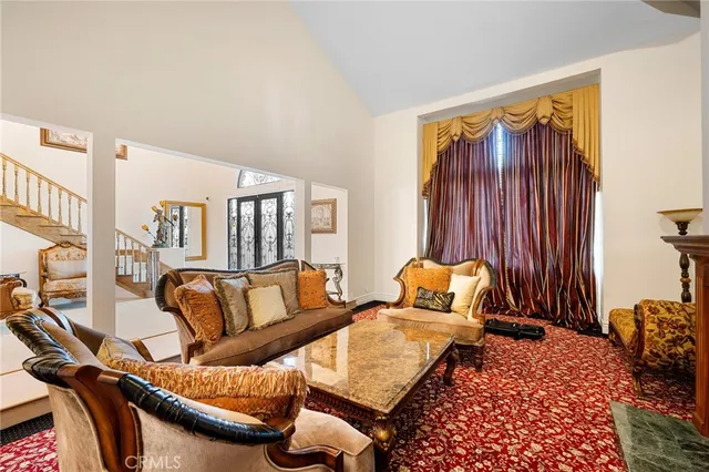 a bedroom with furniture and a large window