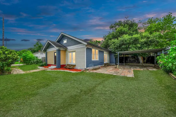 a front view of a house with yard patio and green space