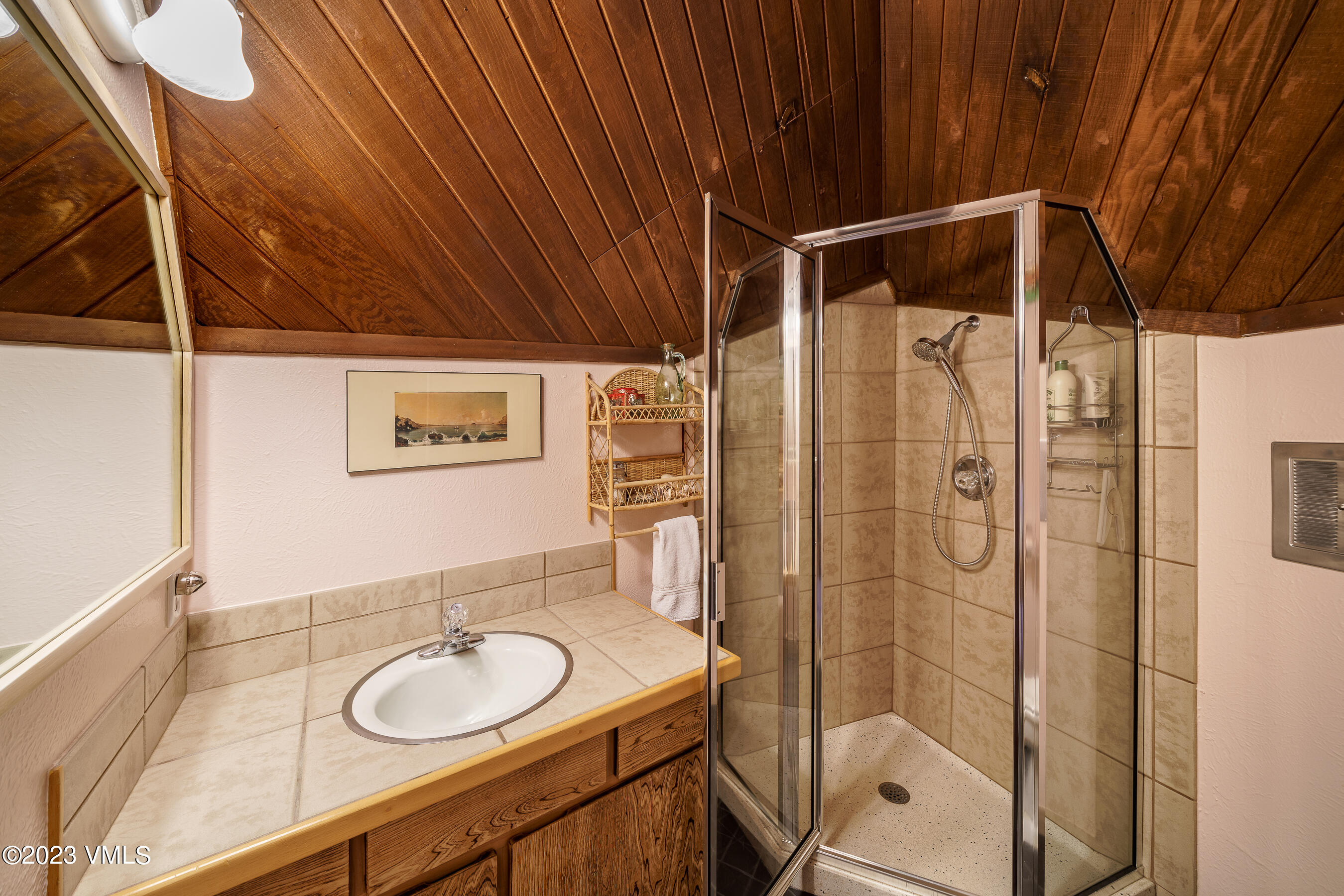 1400 Lions Ridge Loop, Unit A2 Vail, CO 81657 - Photo 12 of 38 a bathroom with a sink vanity granite and shower