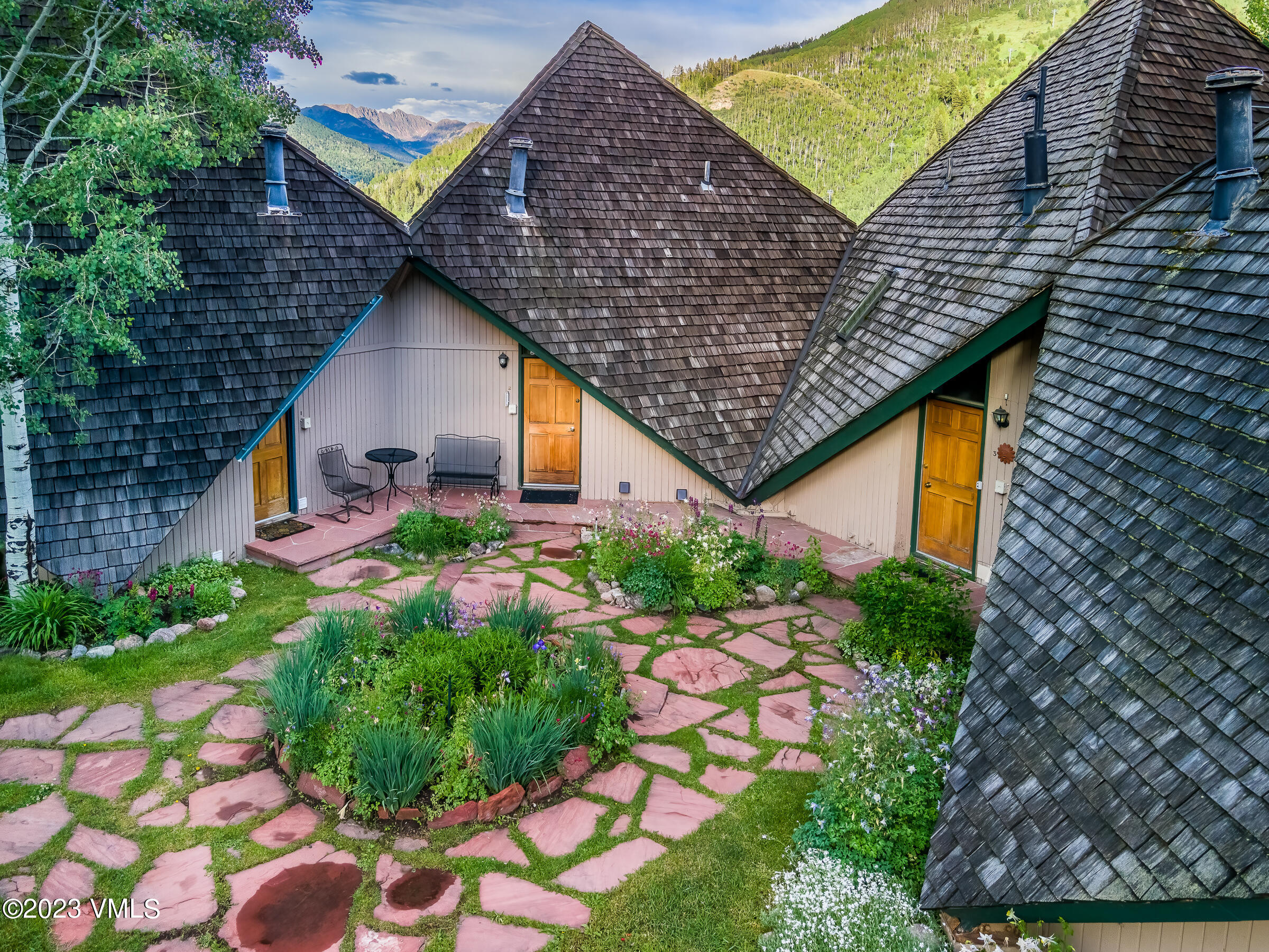 1400 Lions Ridge Loop, Unit A2 Vail, CO 81657 - Photo 2 of 38 a aerial view of a house with swimming pool and garden
