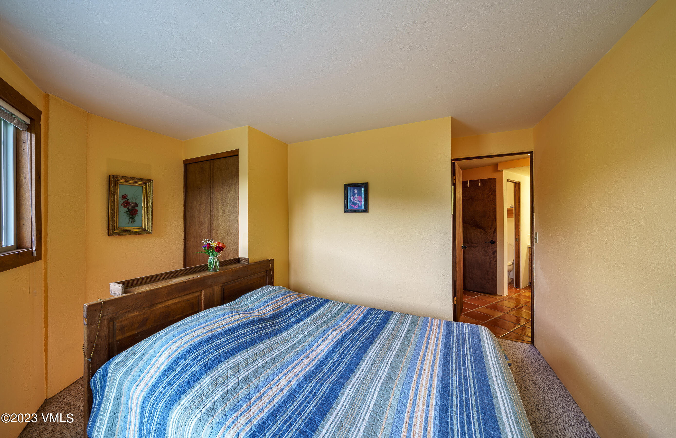 1400 Lions Ridge Loop, Unit A2 Vail, CO 81657 - Photo 22 of 38 a bedroom with a bed and wooden floor