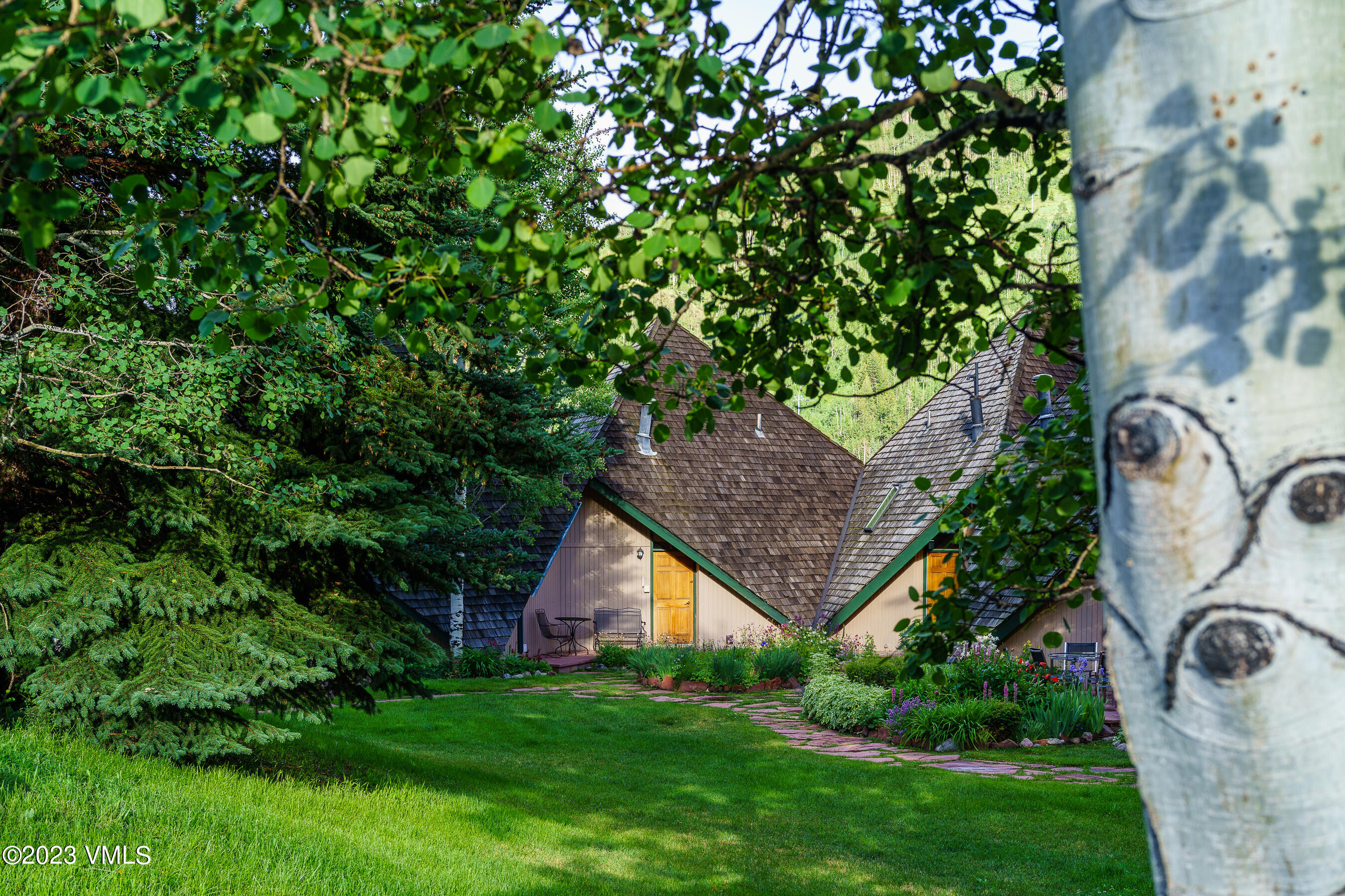 1400 Lions Ridge Loop, Unit A2 Vail, CO 81657 - Photo 24 of 38 a view of a backyard with barn and plants