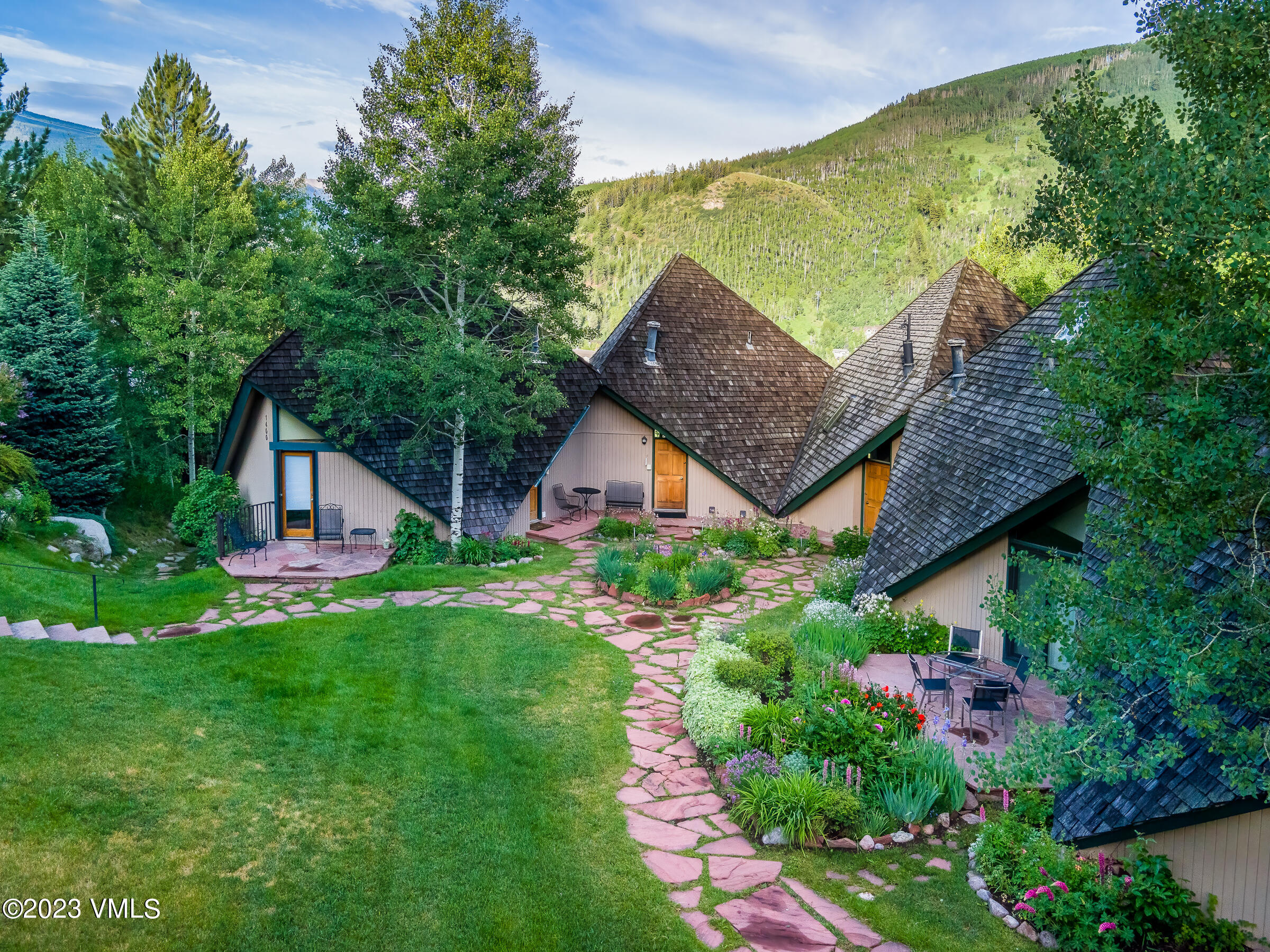 1400 Lions Ridge Loop, Unit A2 Vail, CO 81657 - Photo 27 of 38 a front view of house with garden