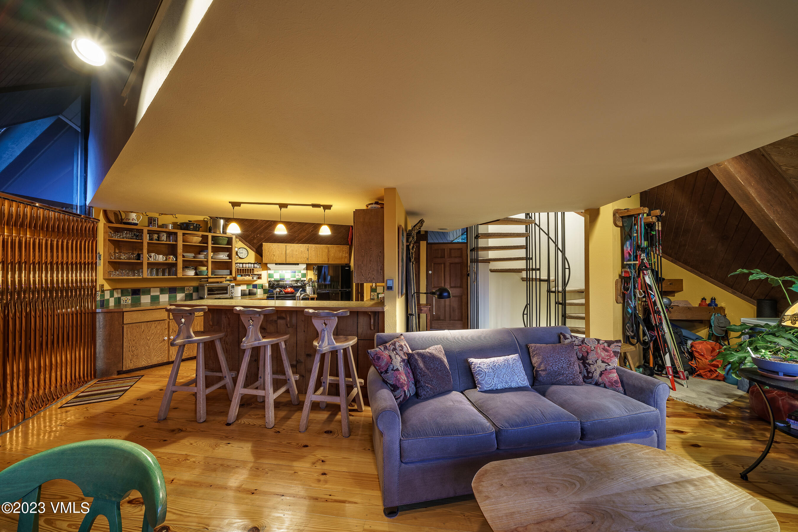 1400 Lions Ridge Loop, Unit A2 Vail, CO 81657 - Photo 33 of 38 a living room with lots of furniture and a view of kitchen