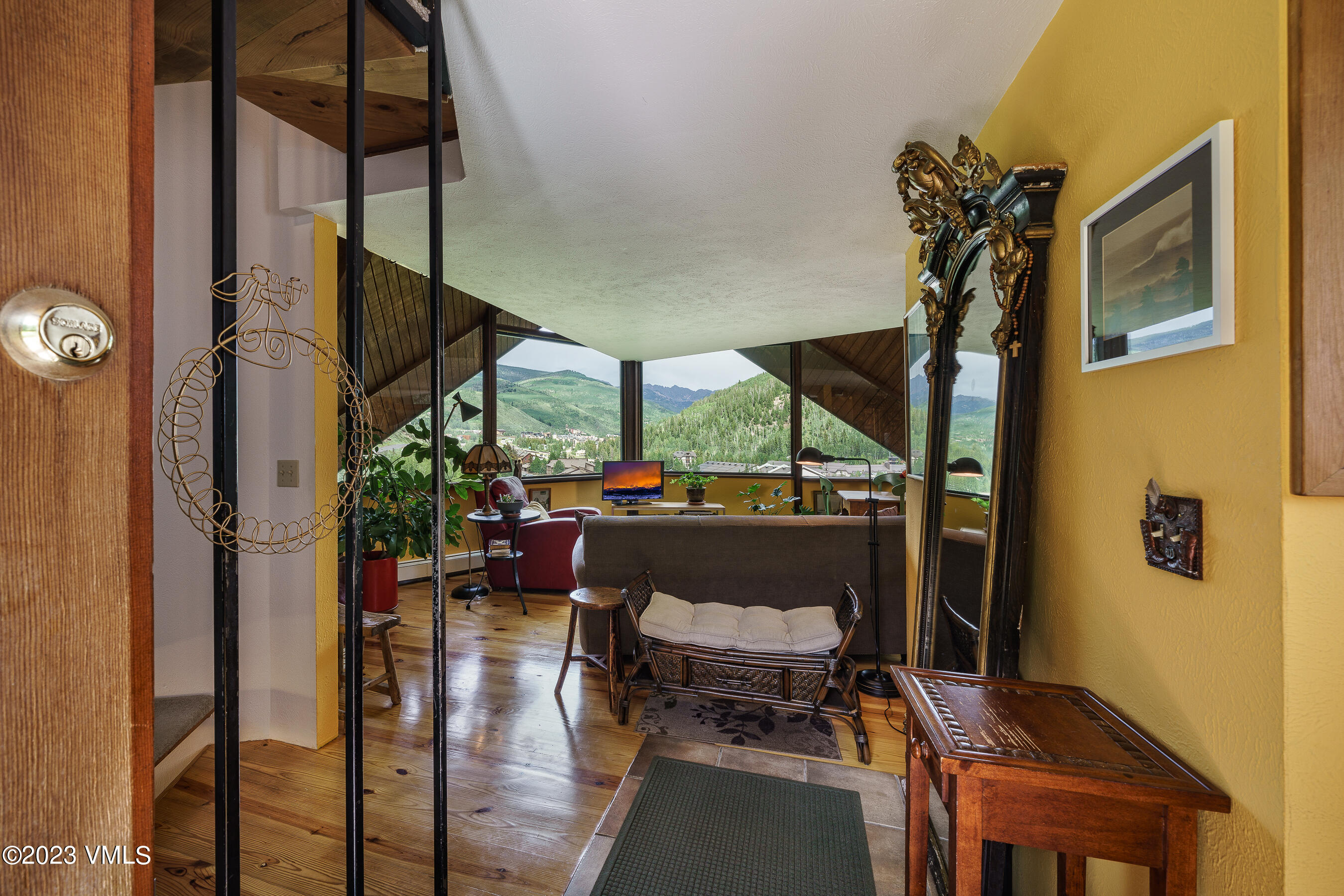 1400 Lions Ridge Loop, Unit A2 Vail, CO 81657 - Photo 4 of 38 a living room with furniture a floor to ceiling window and wooden floor