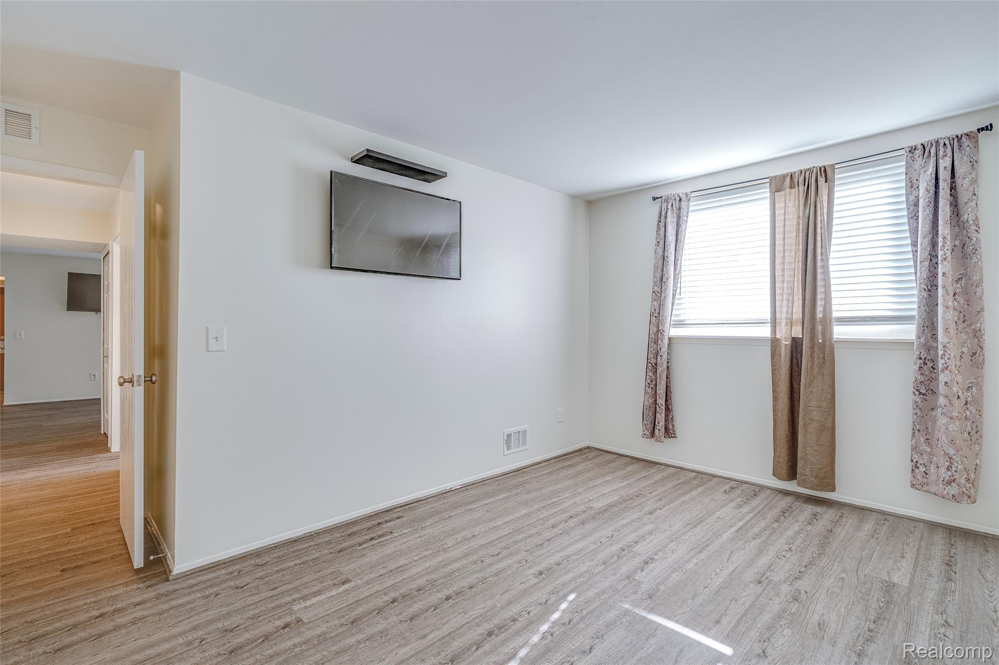 29860 West 12 Mile Road, Unit 604 Farmington, MI 48334 - Photo 12 of 26 Spare room with light wood-style floors and baseboards