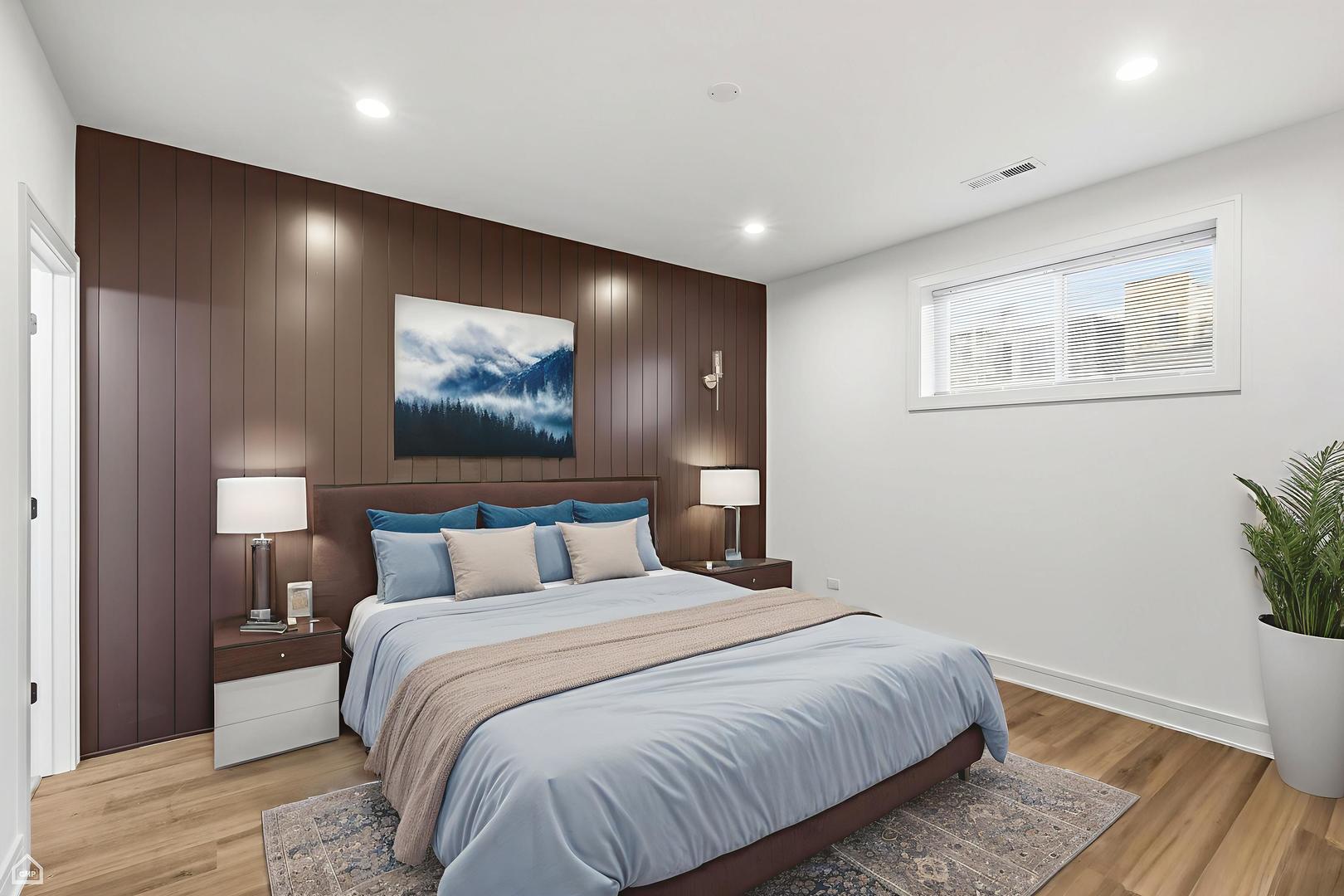 4739 South Indiana Avenue Chicago, IL 60615 - Photo 12 of 38 a bedroom with a large bed and a wooden floor
