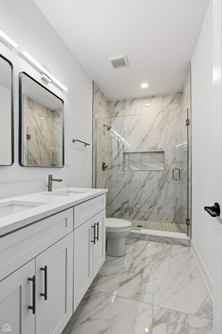 4739 South Indiana Avenue Chicago, IL 60615 - Photo 14 of 38 a bathroom with a double vanity sink toilet and shower