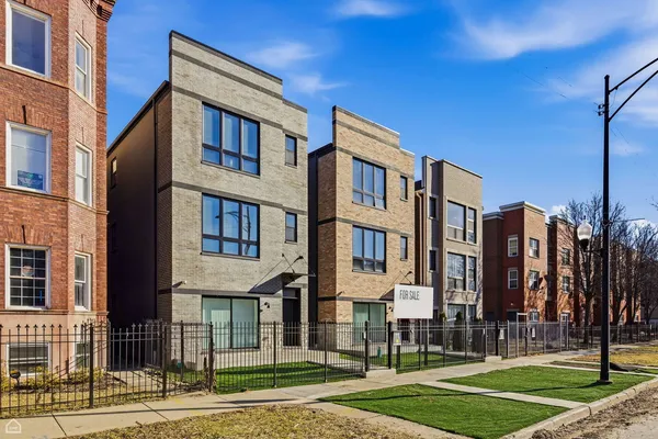 a view of a brick building next to a yard