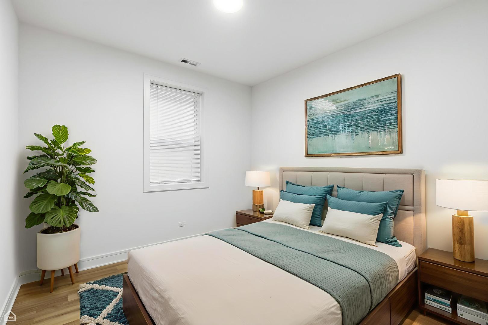 4739 South Indiana Avenue Chicago, IL 60615 - Photo 22 of 38 a bedroom with a bed and a potted plant