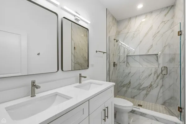 a bathroom with a sink toilet and shower