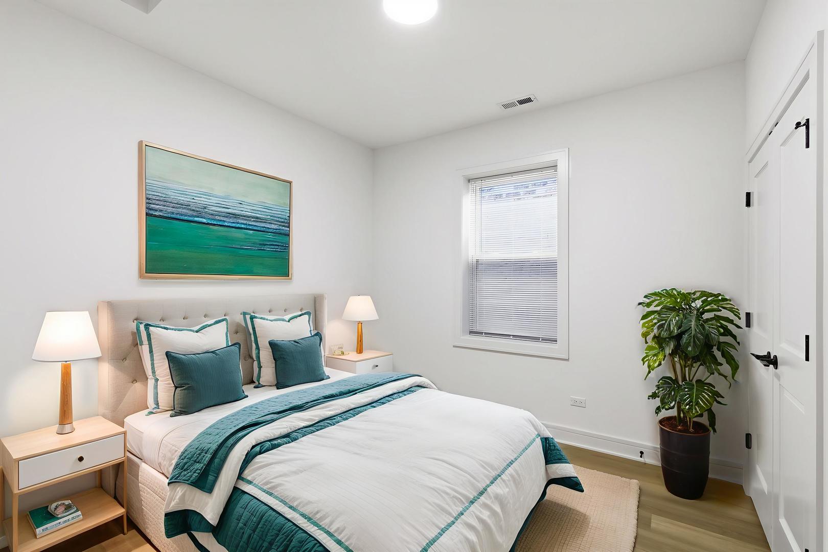 4739 South Indiana Avenue Chicago, IL 60615 - Photo 32 of 38 a bedroom with a bed and a potted plant