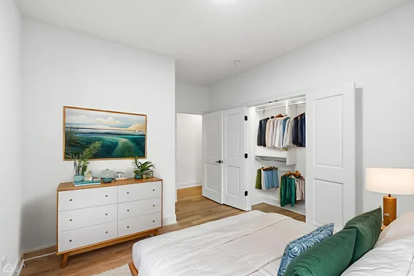a bedroom with a bed and a flat screen tv