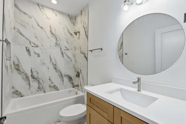 a bathroom with a sink toilet and shower