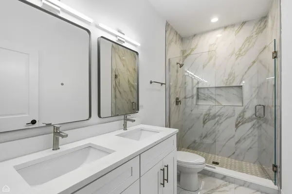 a bathroom with a sink toilet and shower