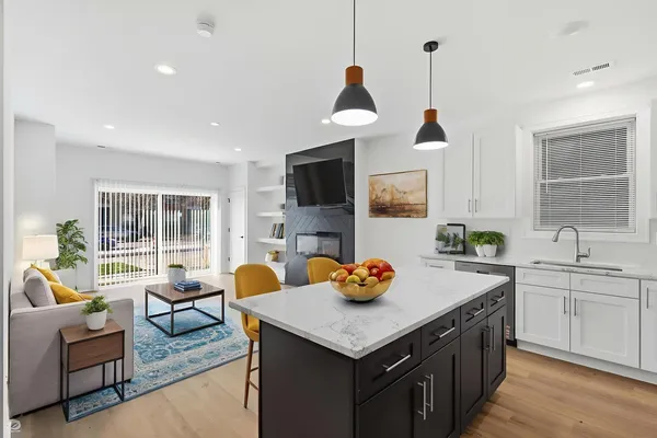a kitchen with a sink a counter space and living room view