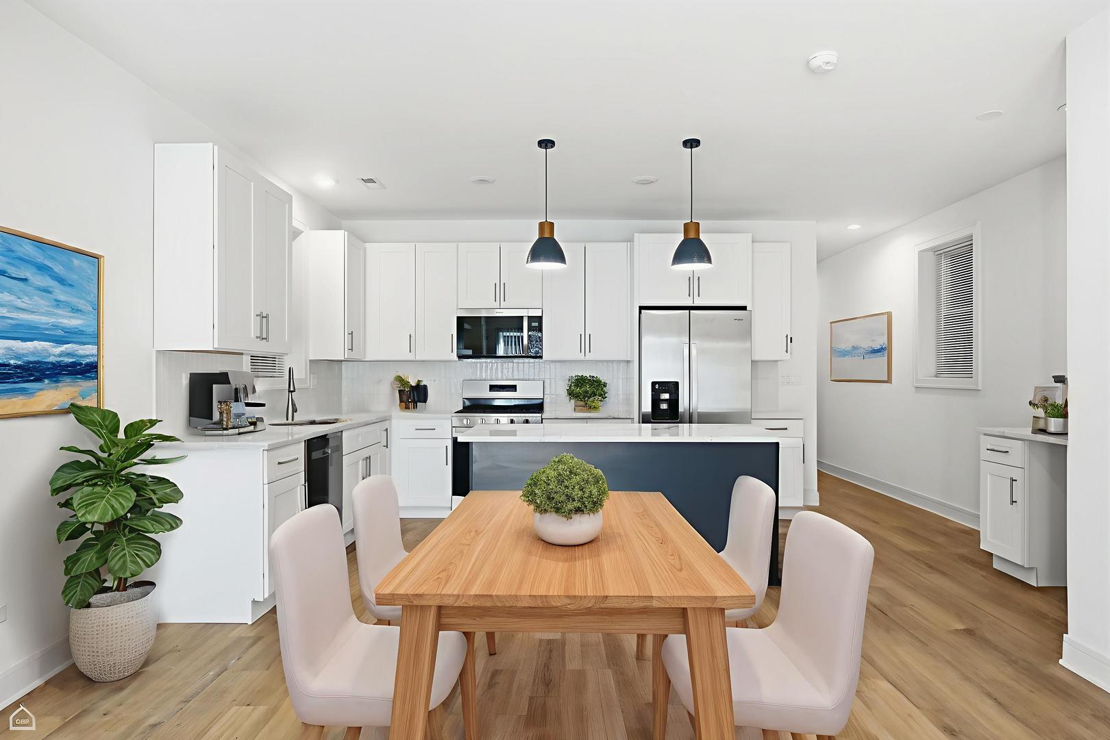 4739 South Indiana Avenue Chicago, IL 60615 - Photo 6 of 38 a kitchen with stainless steel appliances granite countertop a stove a kitchen island a stove a table and chairs